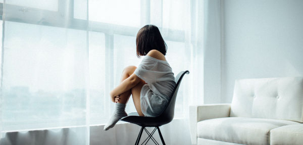 A person lost in thought looking out the window